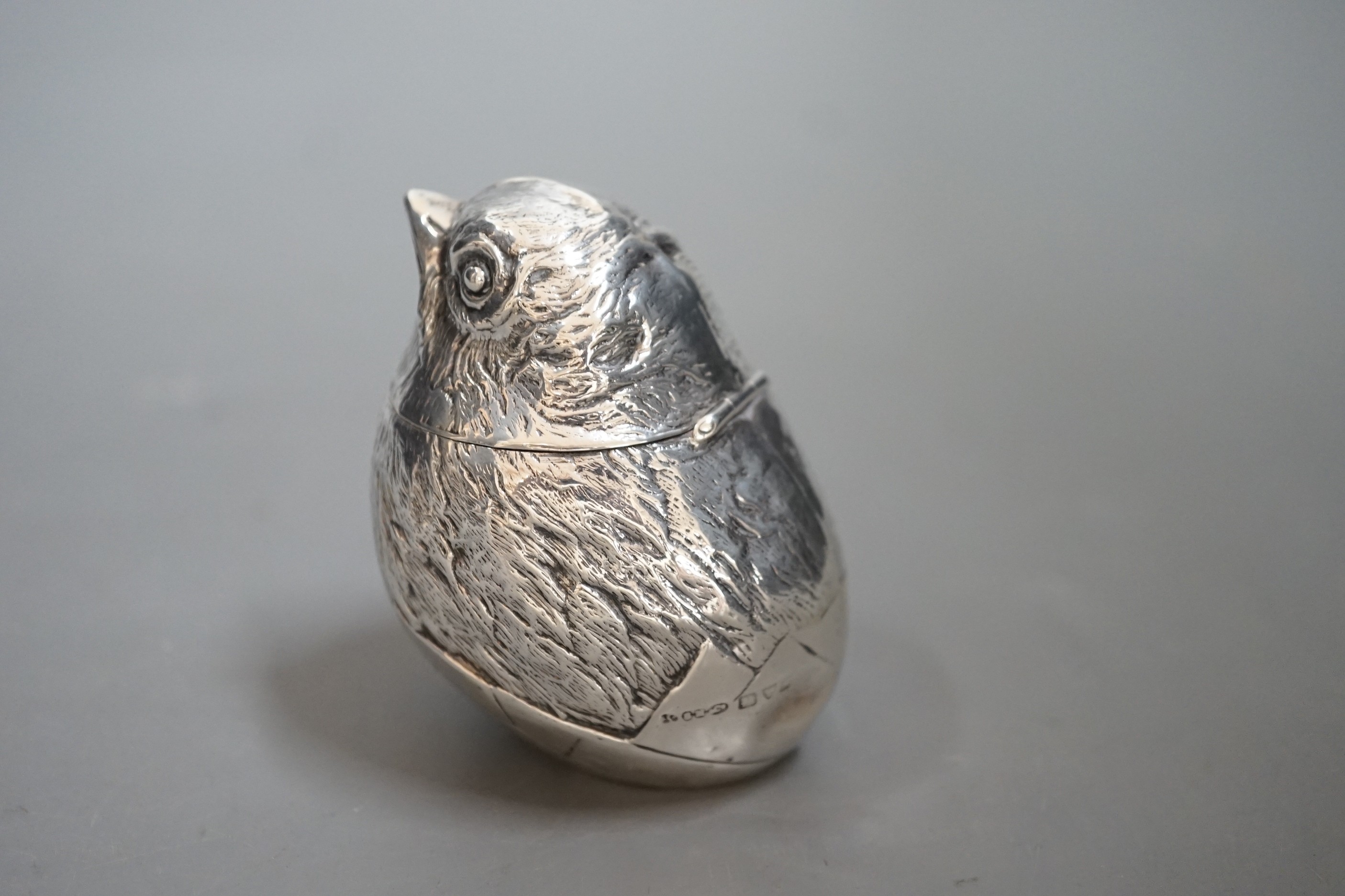 An early 20th century silver box with hinged cover, modelled as a hatching chick, Sampson Mordan & Co, Chester ?, marks rubbed, 64mm.